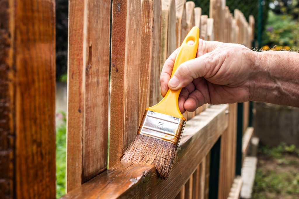 staining a wooden fence