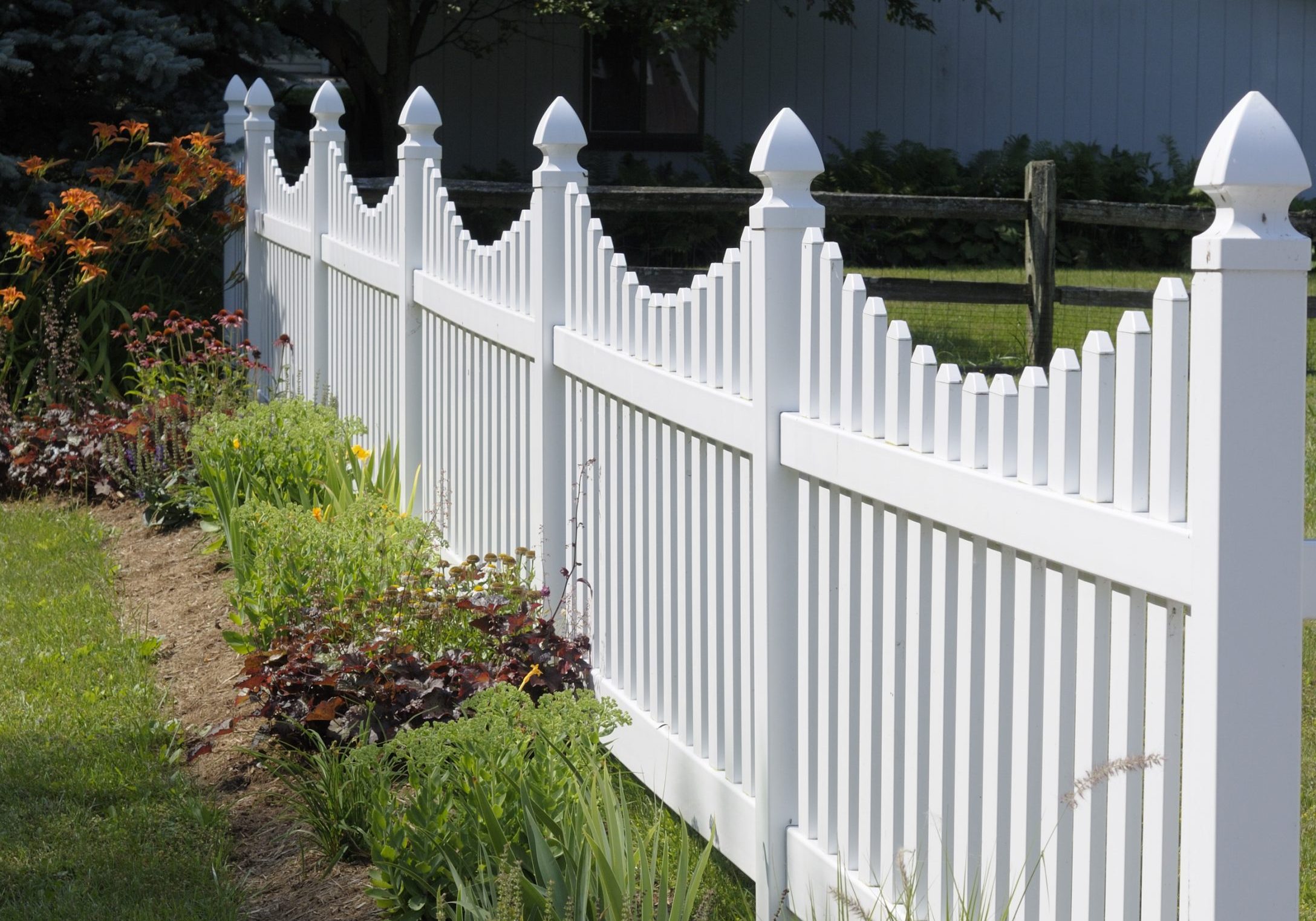 white vinyl fence around a residential garden to stop rabbits